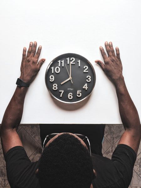 Man sitting before clock